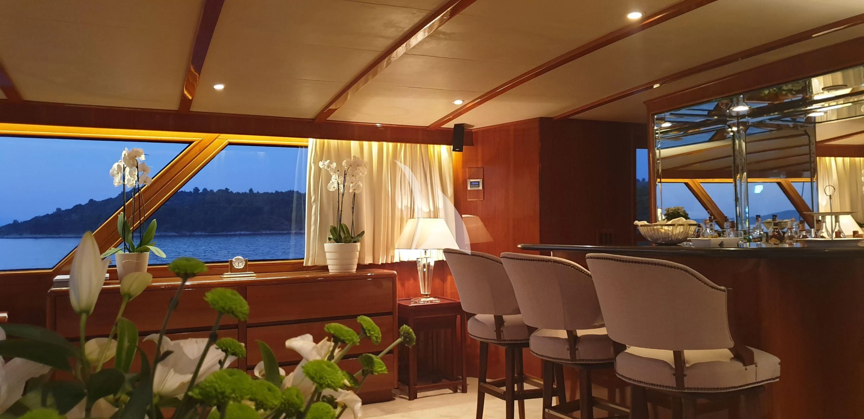 a room with a table chairs and a window with a view of the ocean aboard AURIANE Yacht for Sale