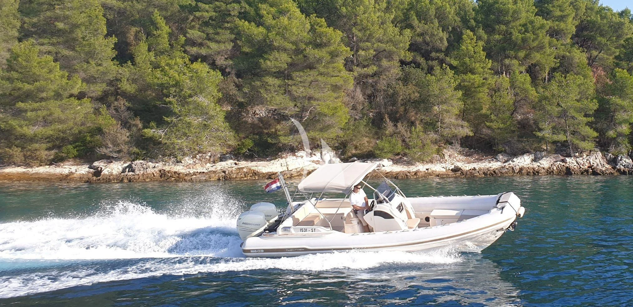 a man driving a boat on a river aboard AURIANE Yacht for Sale