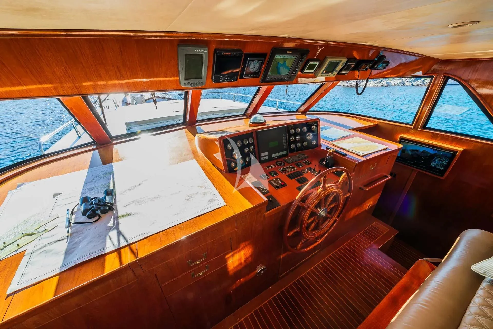 a room with a wood paneled wall and a wood table with pictures on it aboard AURIANE Yacht for Sale