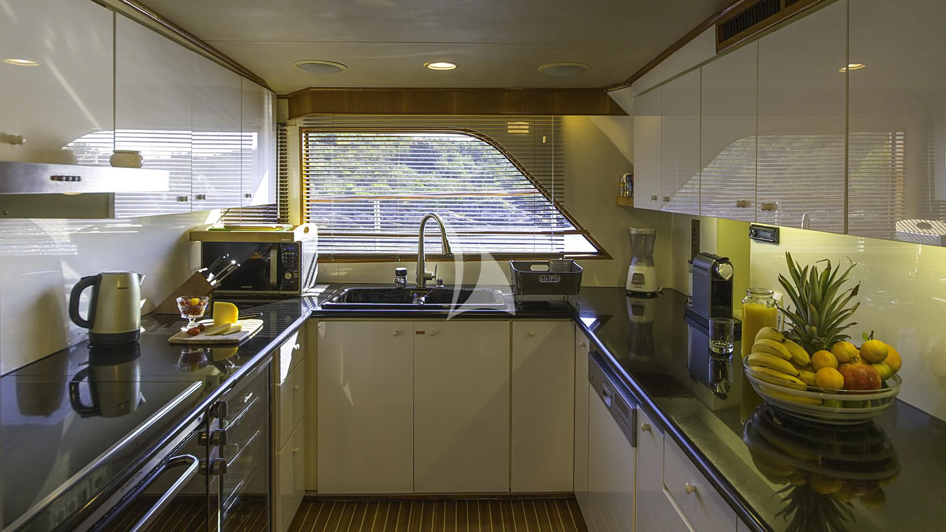 a kitchen with white cabinets aboard AURIANE Yacht for Sale