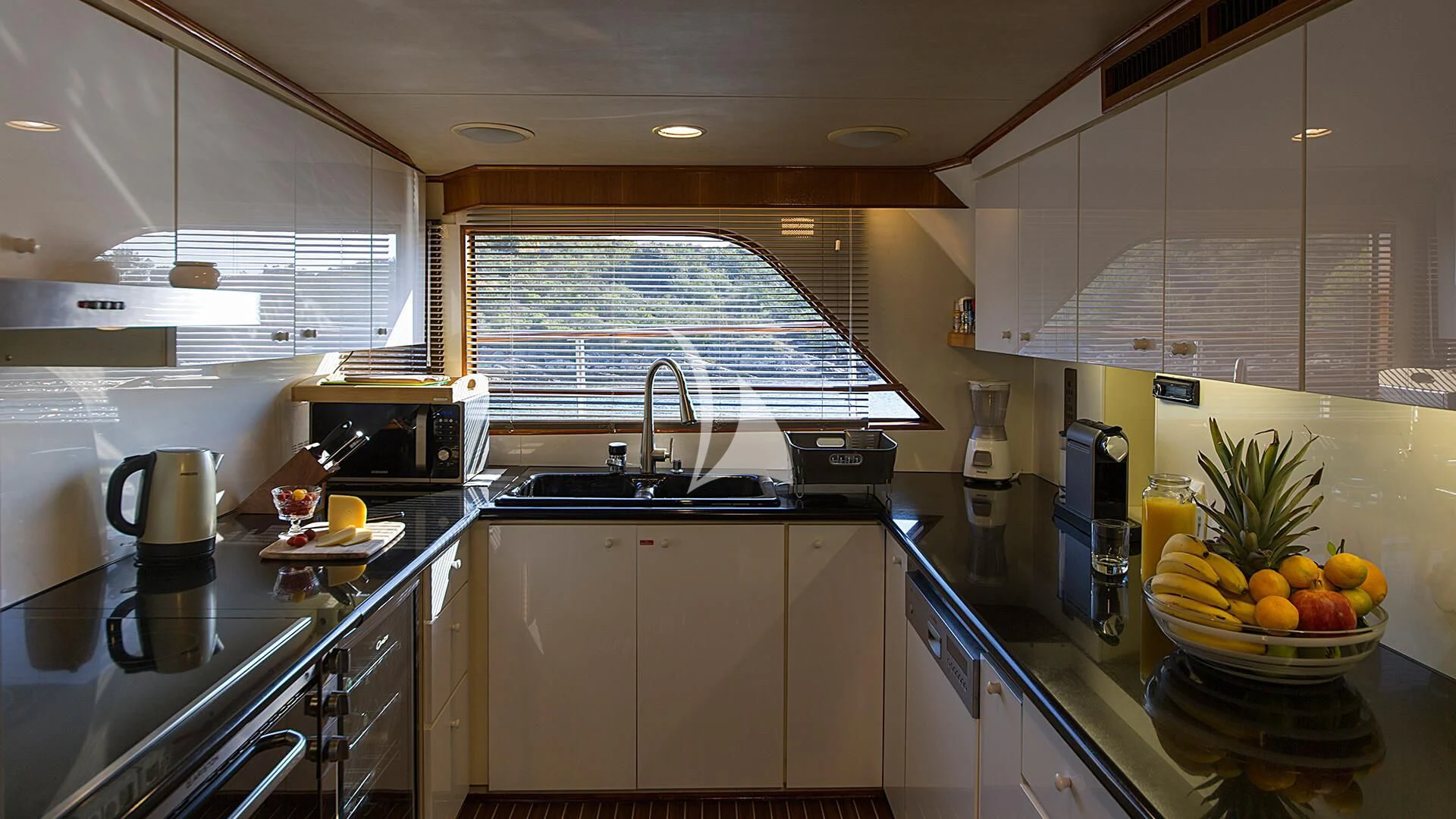 a kitchen with white cabinets aboard AURIANE Yacht for Sale