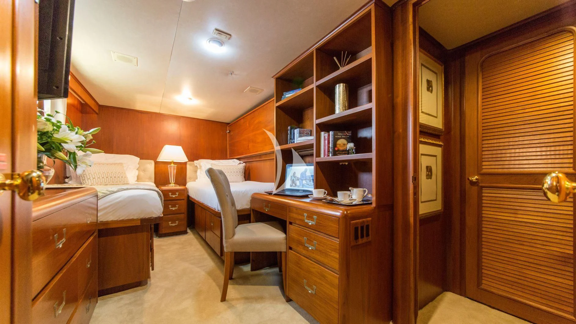 a bedroom with a desk and a bed aboard AURIANE Yacht for Sale