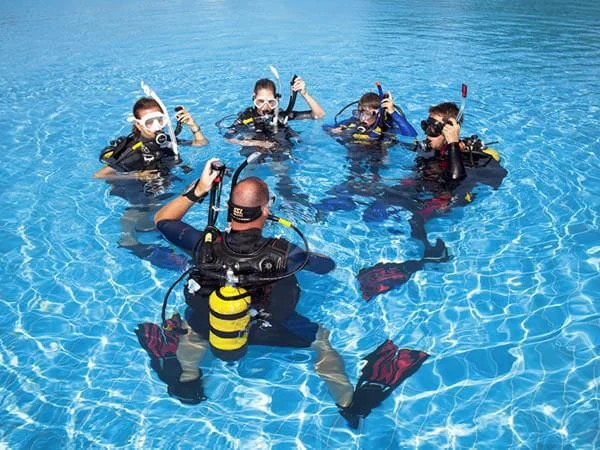 a group of people in scuba gear in a pool aboard AURIANE Yacht for Sale