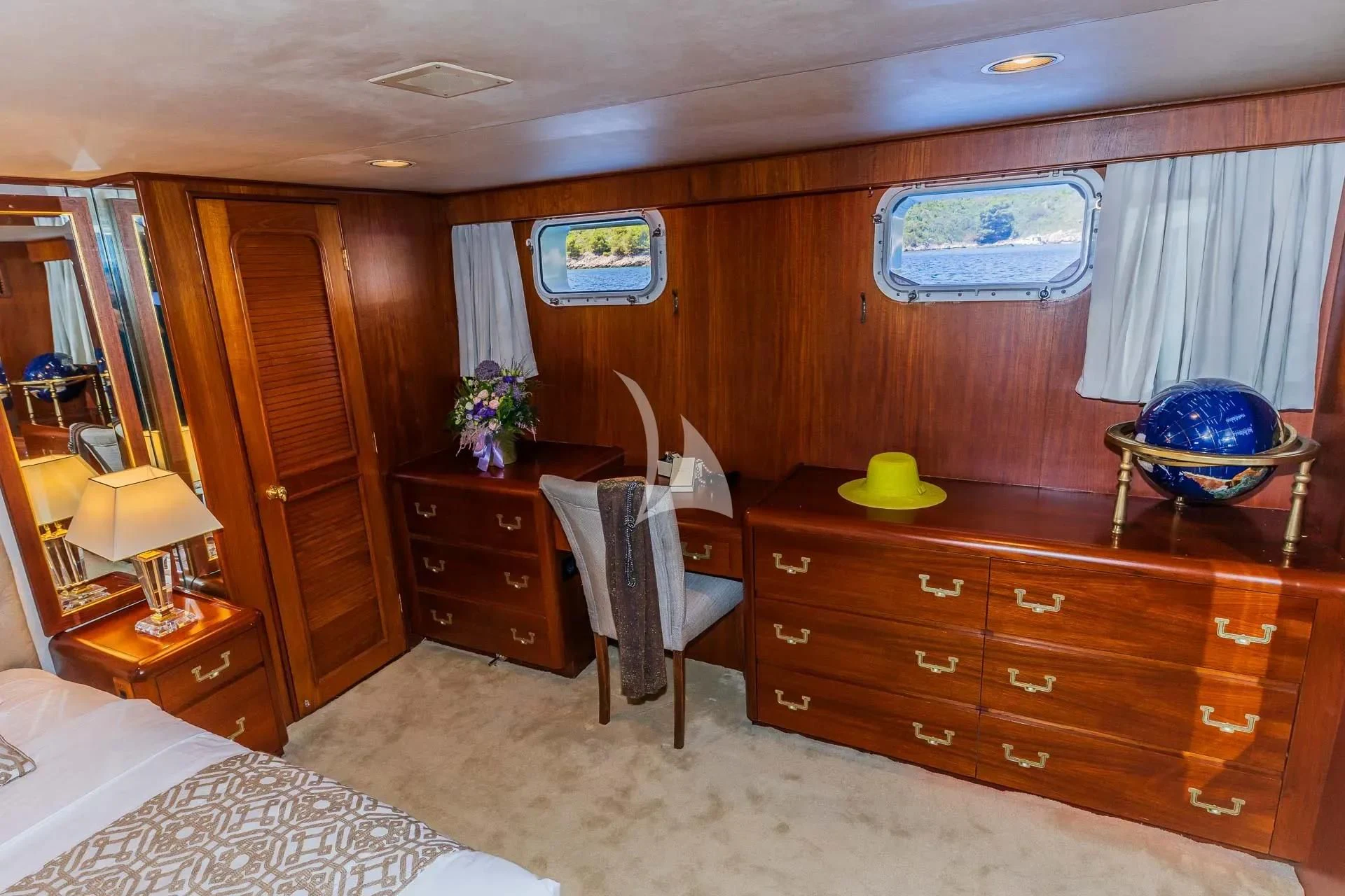a bedroom with a bed and desk aboard AURIANE Yacht for Sale
