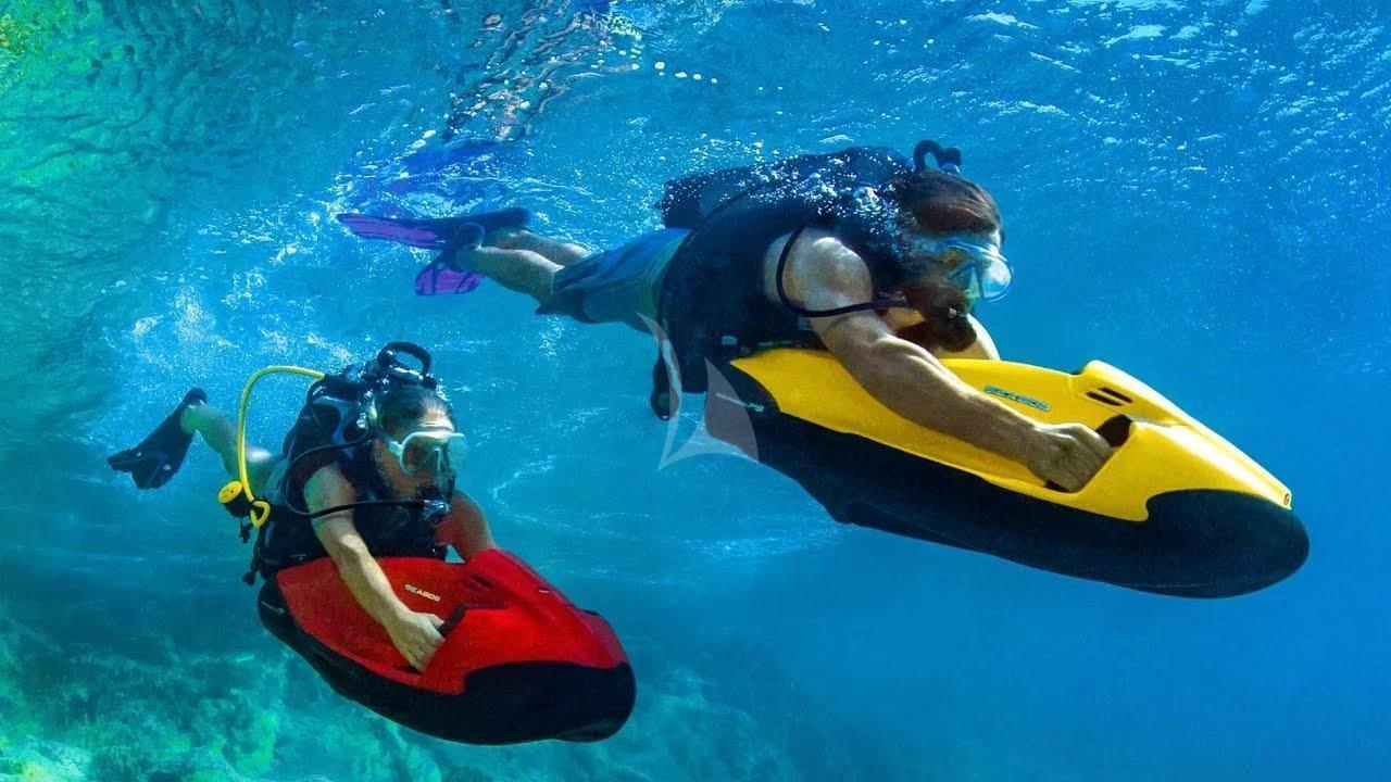 a man and a woman in scuba gear in a pool aboard AURIANE Yacht for Sale