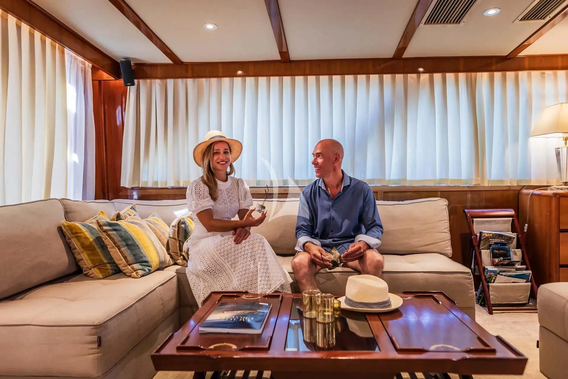 a couple sitting on a couch aboard AURIANE Yacht for Sale
