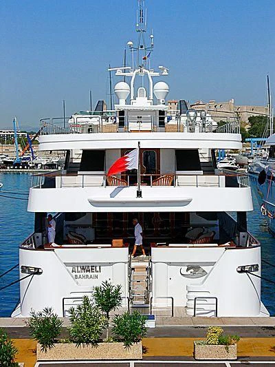 a large white boat with flags on it aboard ALWAELI Yacht for Sale