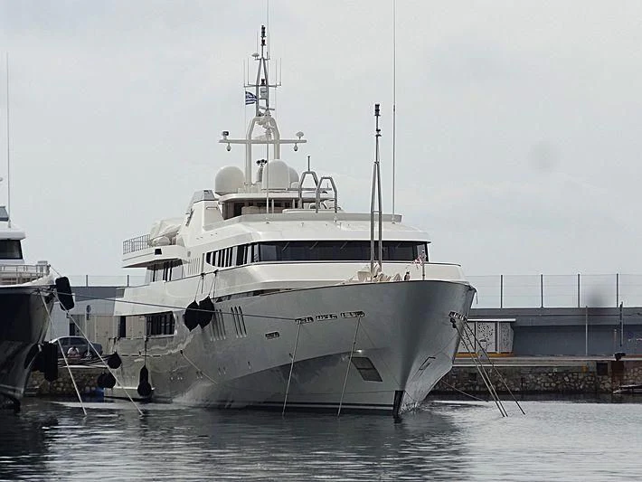 a large white boat in a harbor aboard ALWAELI Yacht for Sale