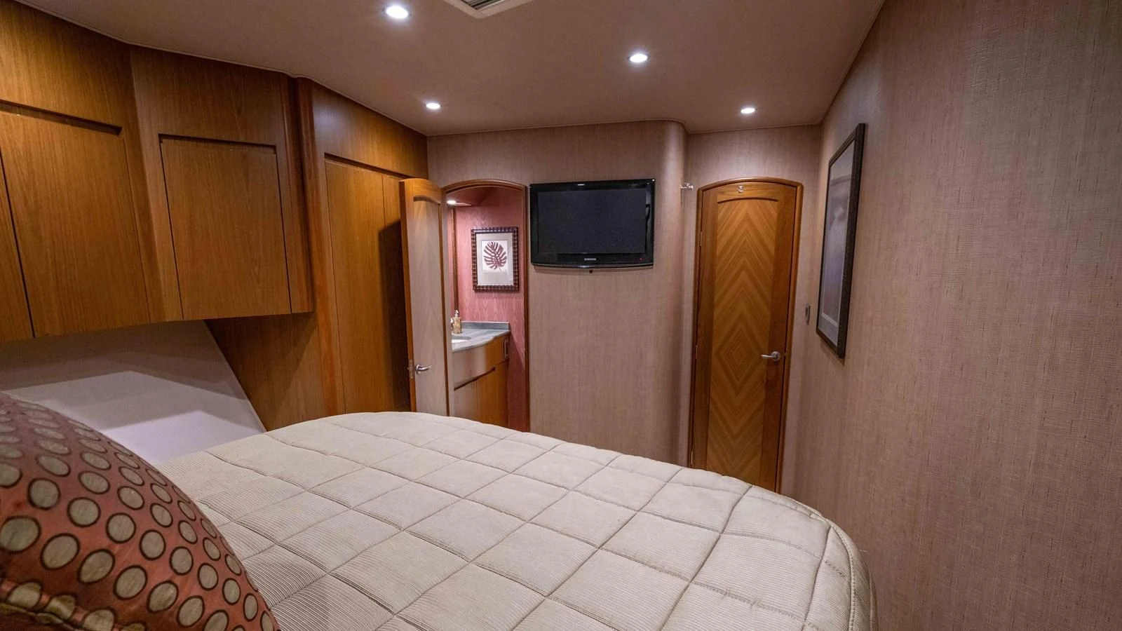 a bedroom with a bed and television aboard DONE DEAL Yacht for Sale