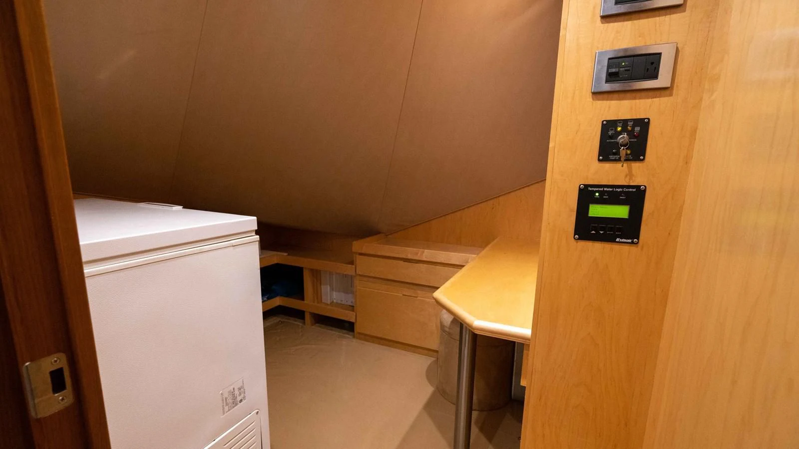a small room with a small refrigerator aboard DONE DEAL Yacht for Sale