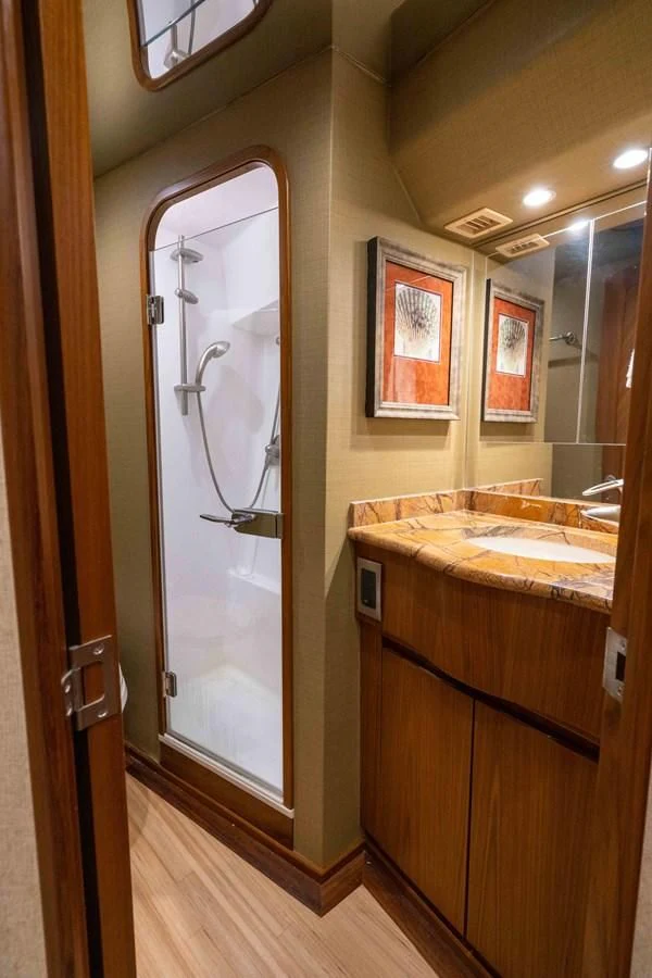 a bathroom with a large mirror aboard DONE DEAL Yacht for Sale