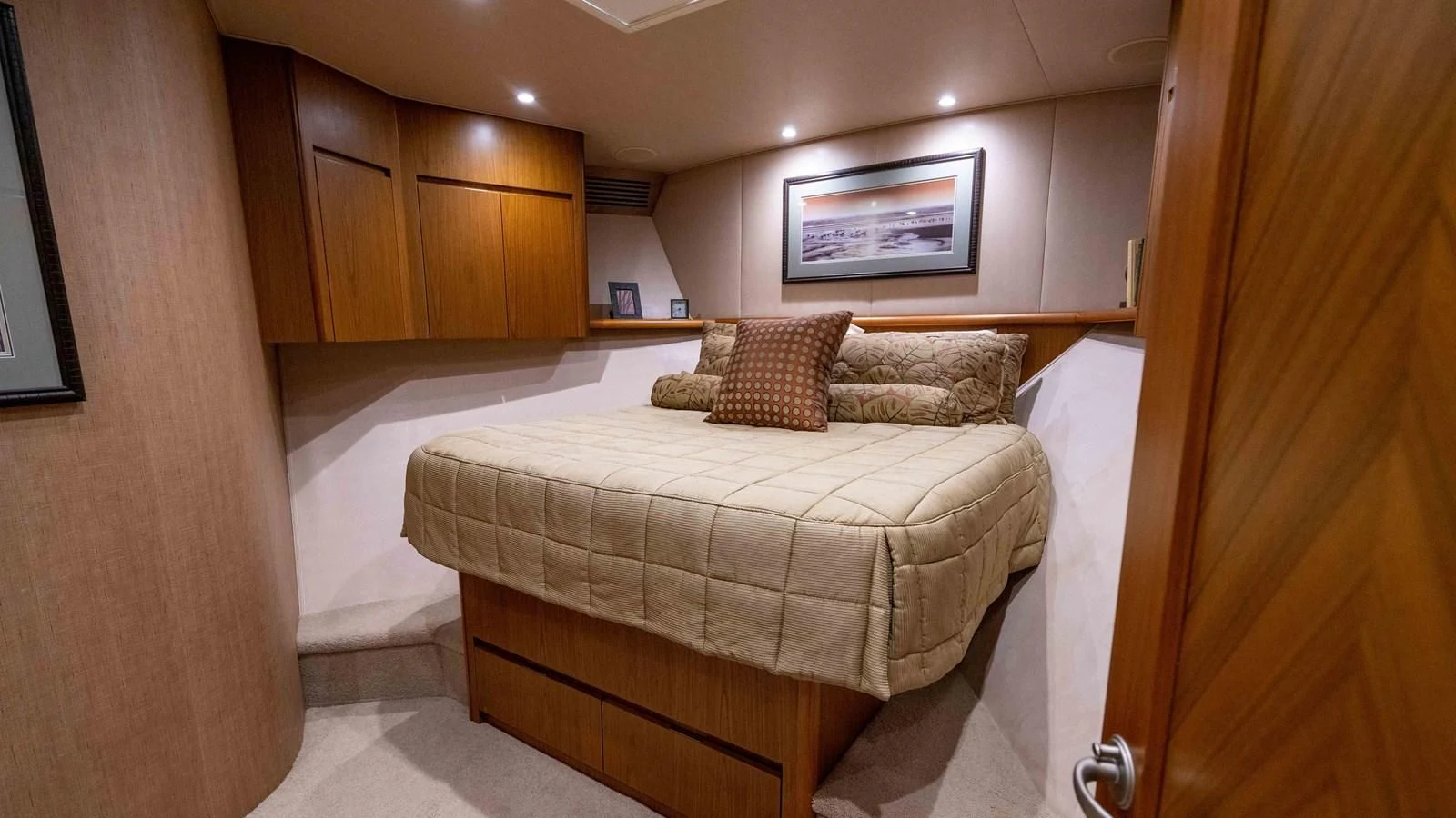 a bedroom with a bed and a wood cabinet aboard DONE DEAL Yacht for Sale