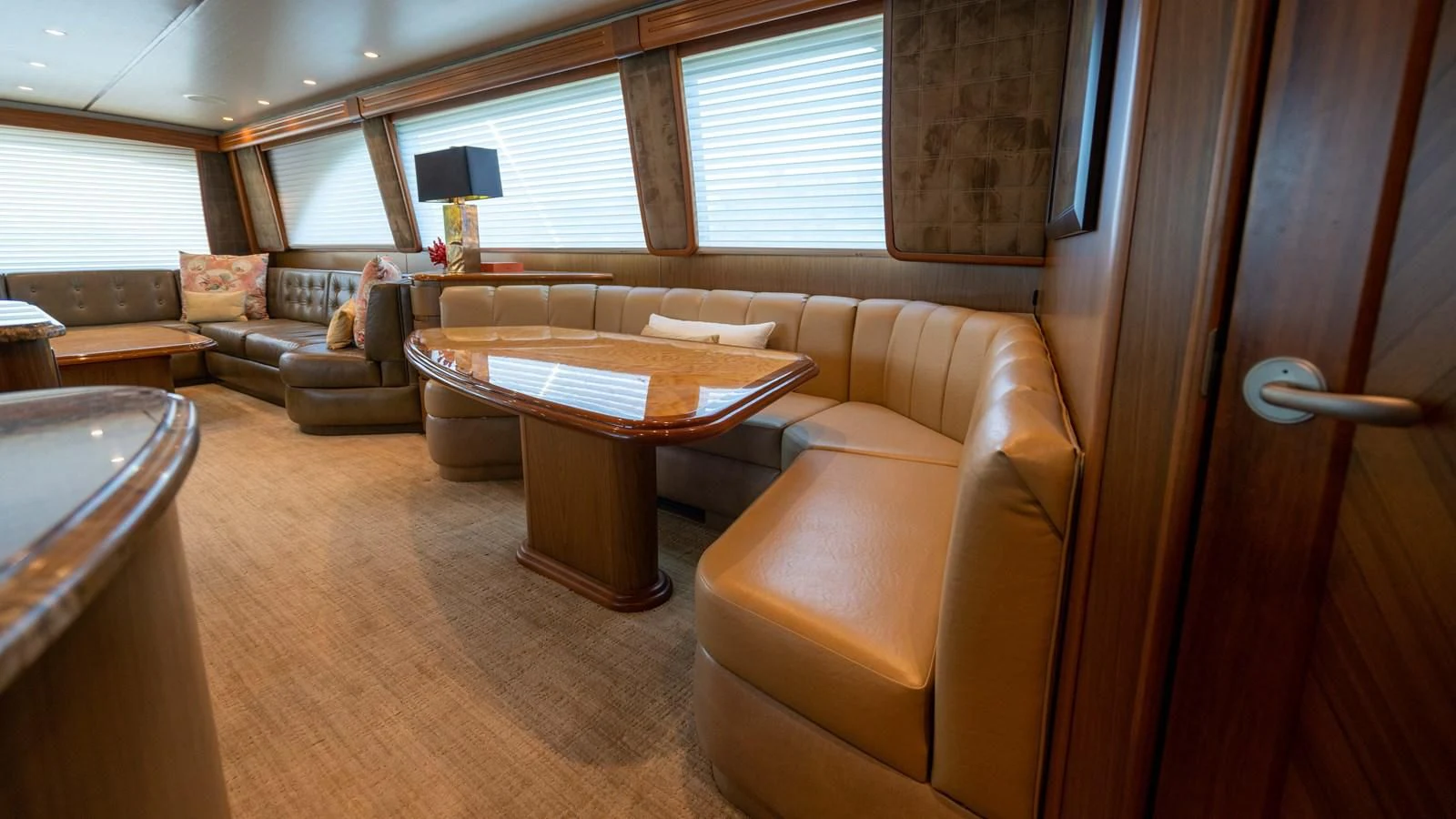 a living room with a table and couches aboard DONE DEAL Yacht for Sale