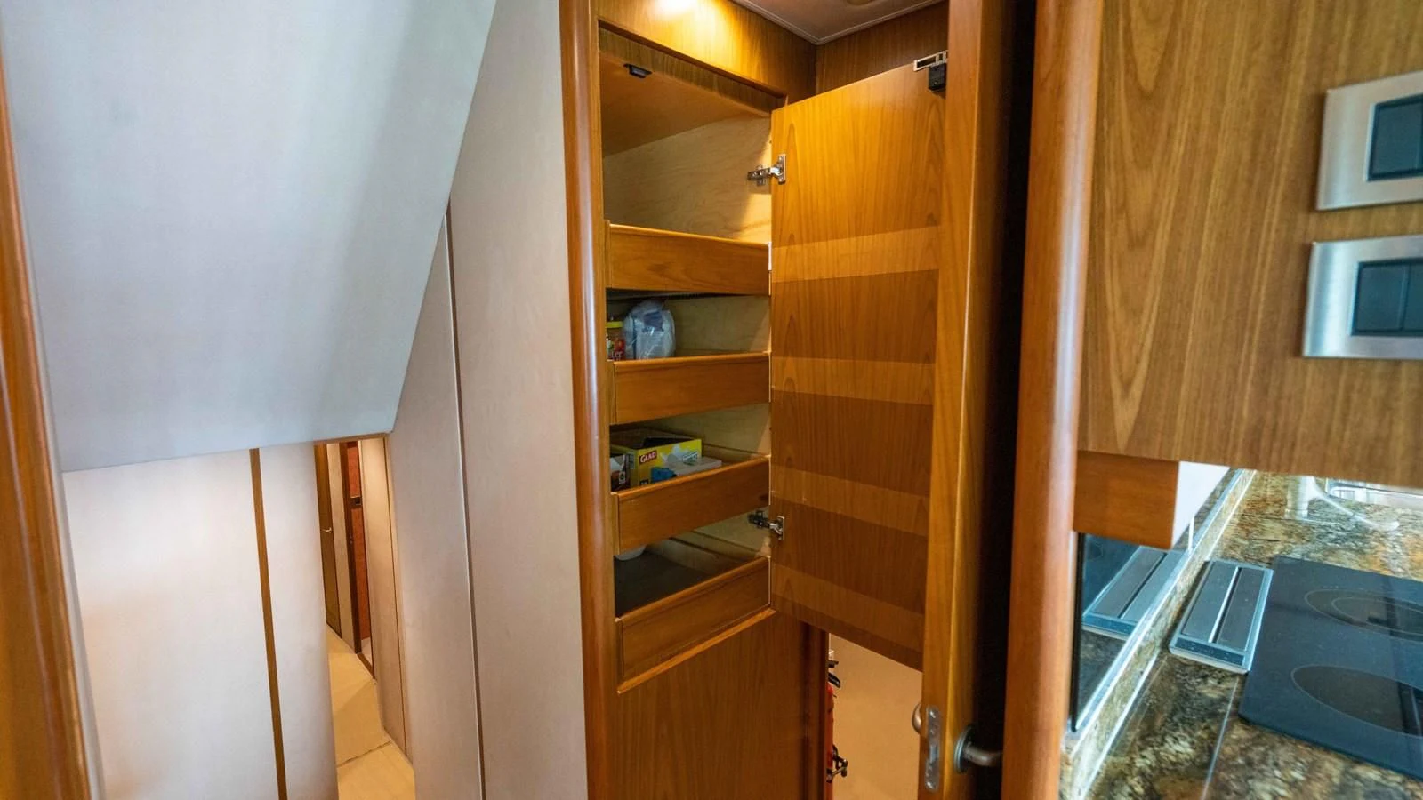 a room with a wood door and a shelf with objects on it aboard DONE DEAL Yacht for Sale