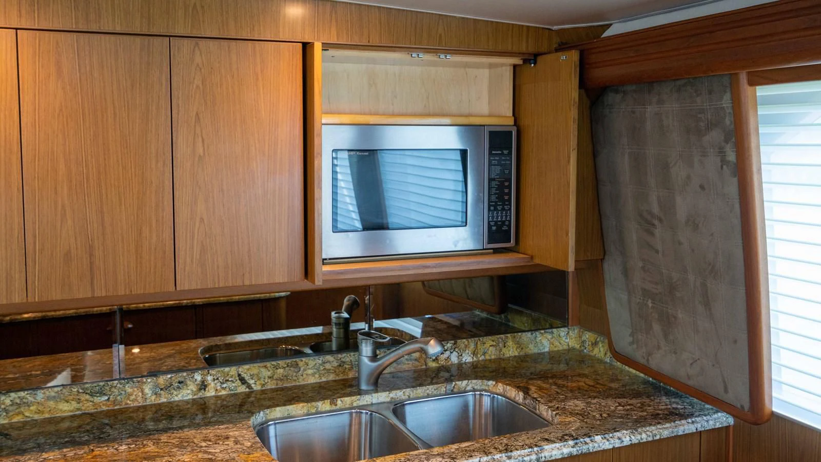 a microwave oven sits over a sink aboard DONE DEAL Yacht for Sale