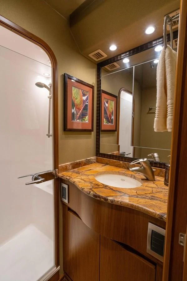 a bathroom with a sink and a mirror aboard DONE DEAL Yacht for Sale
