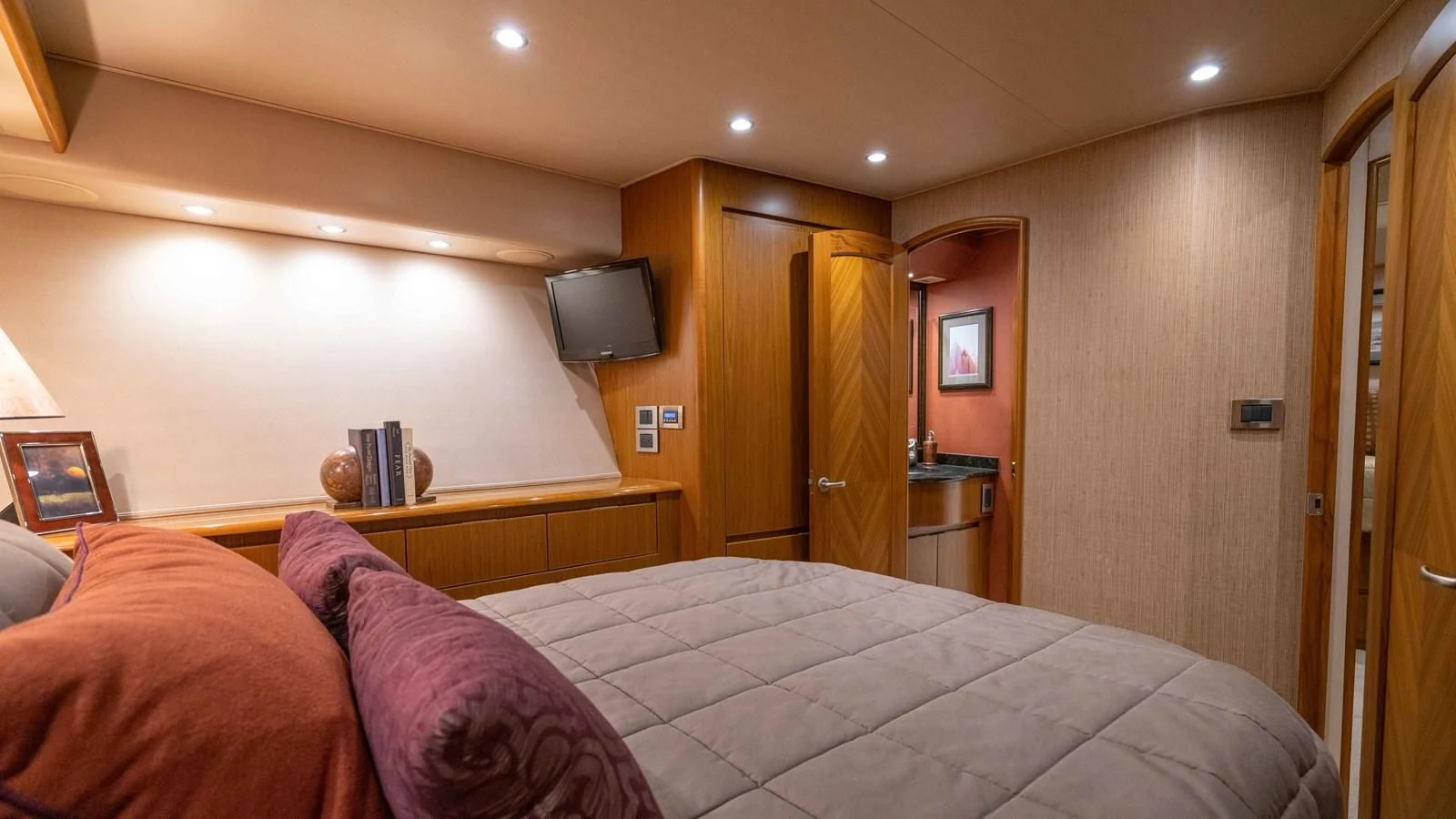a bedroom with a bed and a television aboard DONE DEAL Yacht for Sale