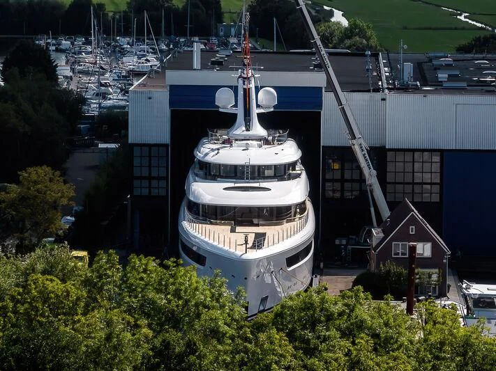 a large white boat in a harbor aboard ALVIA Yacht for Sale