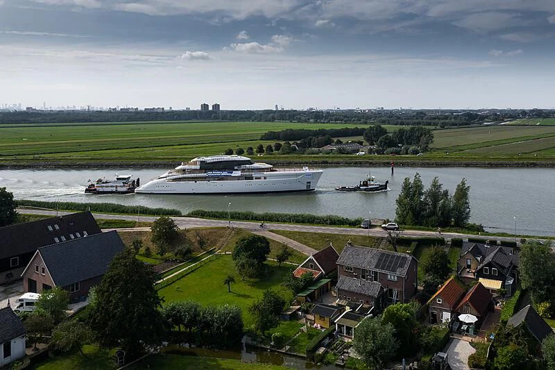 a river with boats and buildings aboard ALVIA Yacht for Sale