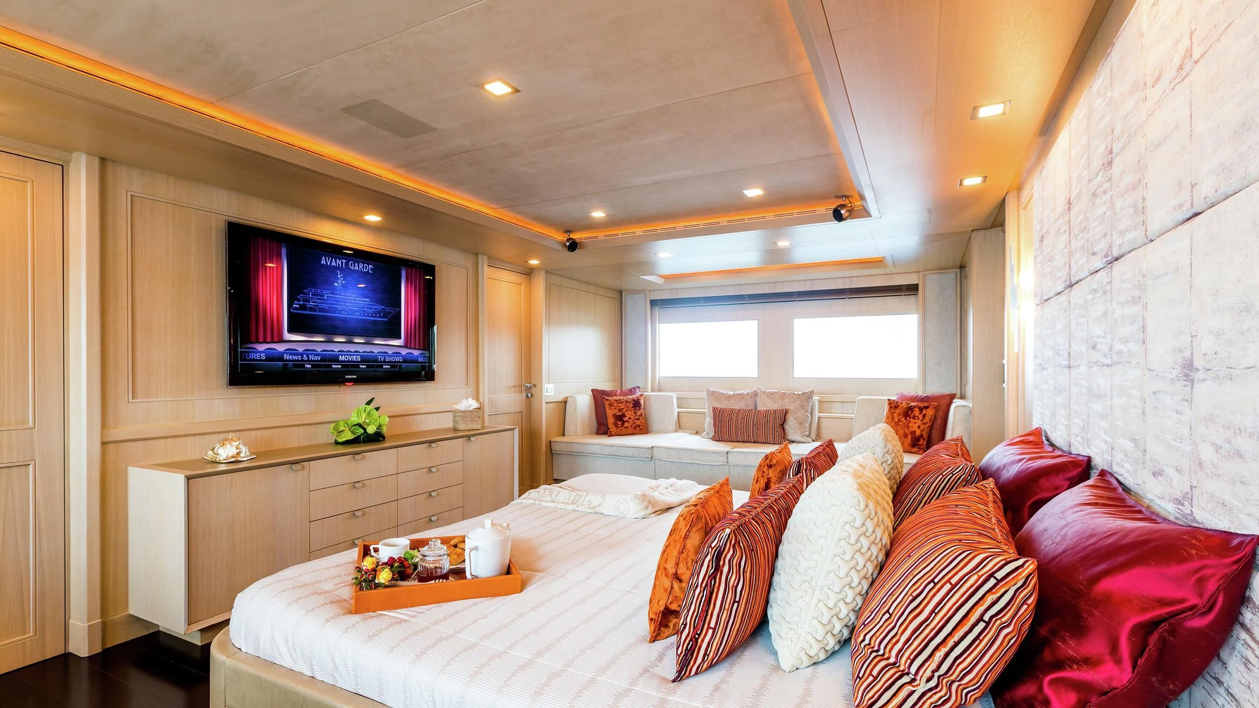 a large bedroom with a large tv aboard PHOTON Yacht for Sale