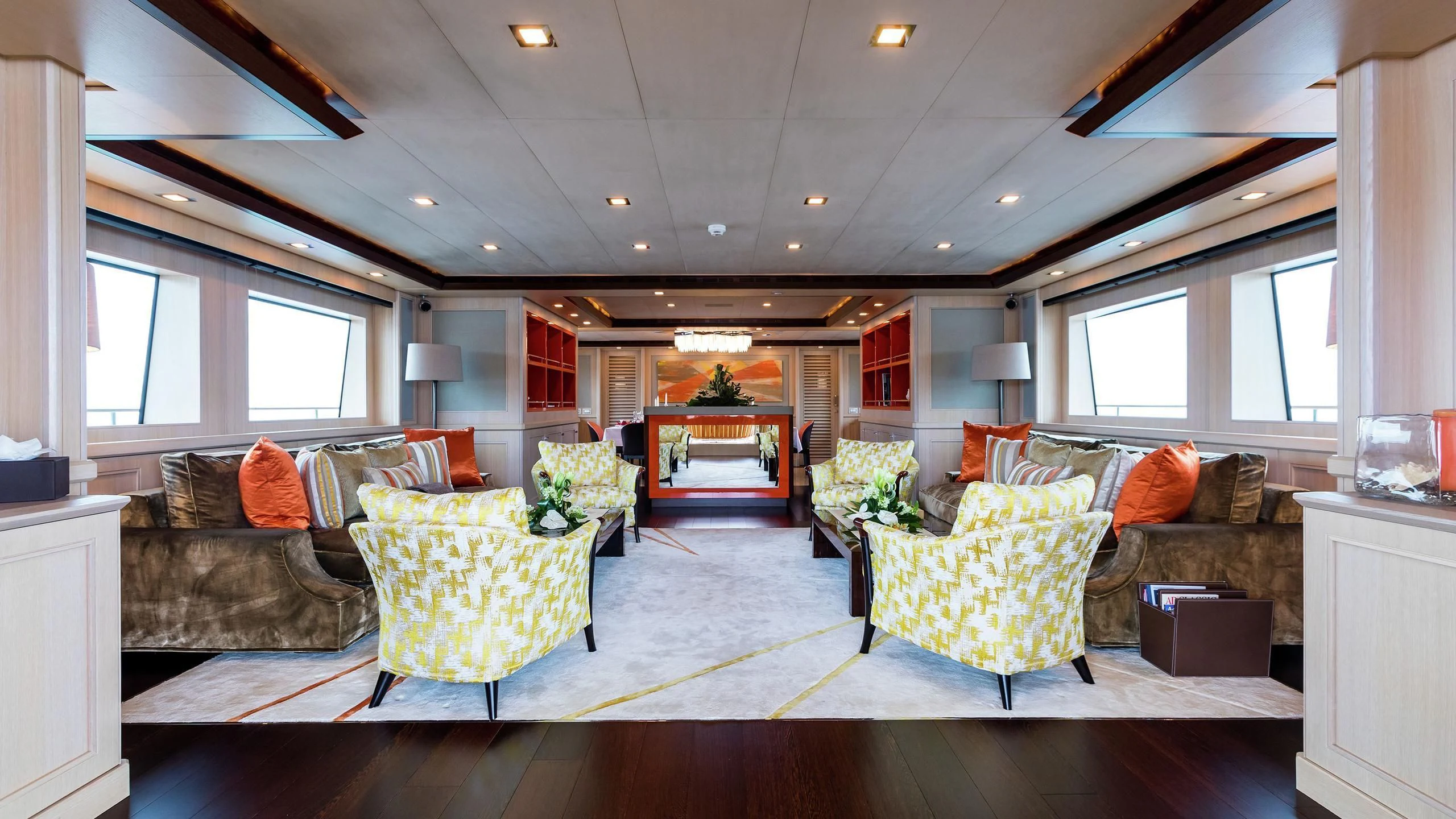 a living room with a couch and a table aboard PHOTON Yacht for Sale