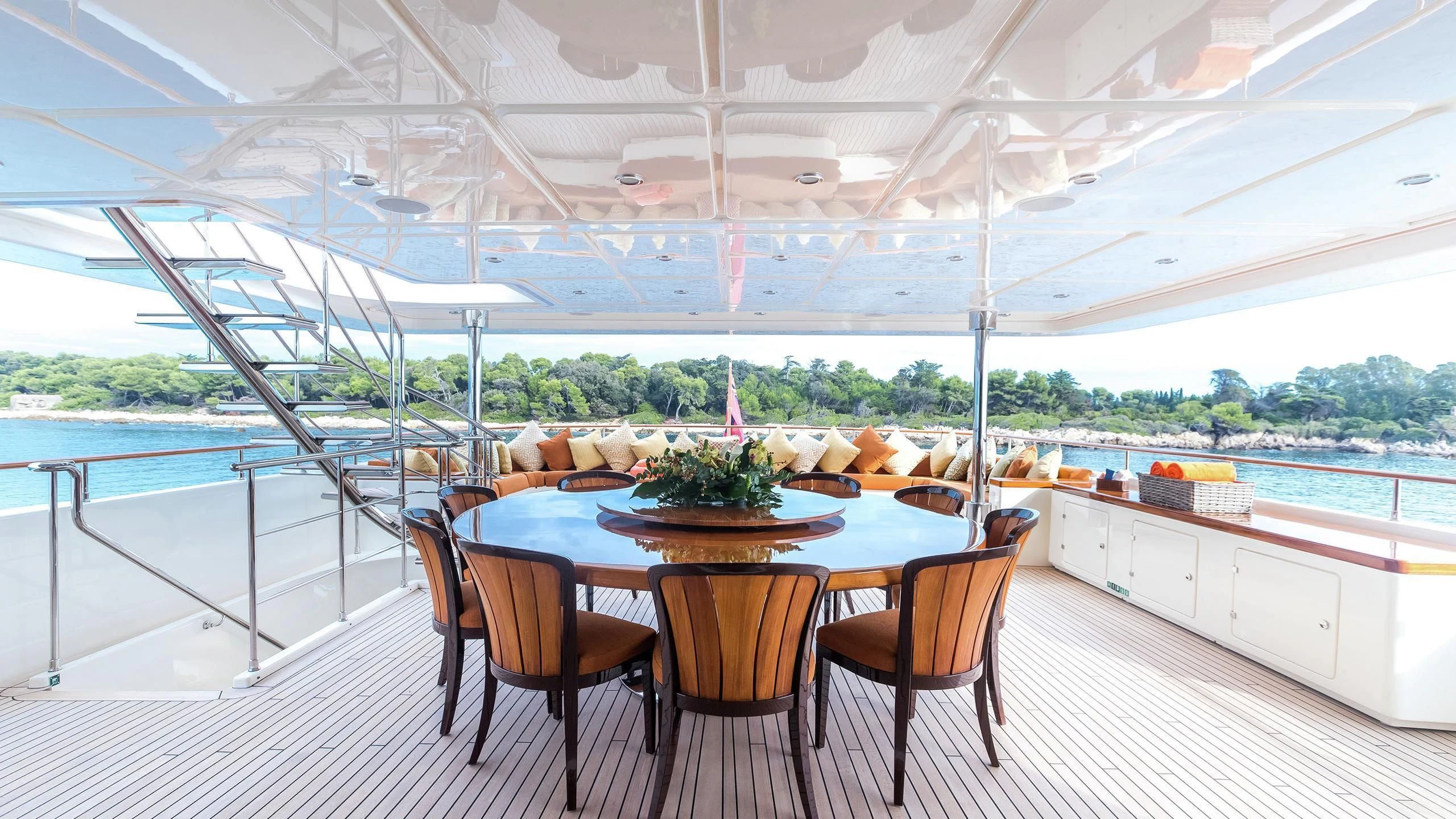 a table with chairs around it aboard PHOTON Yacht for Sale