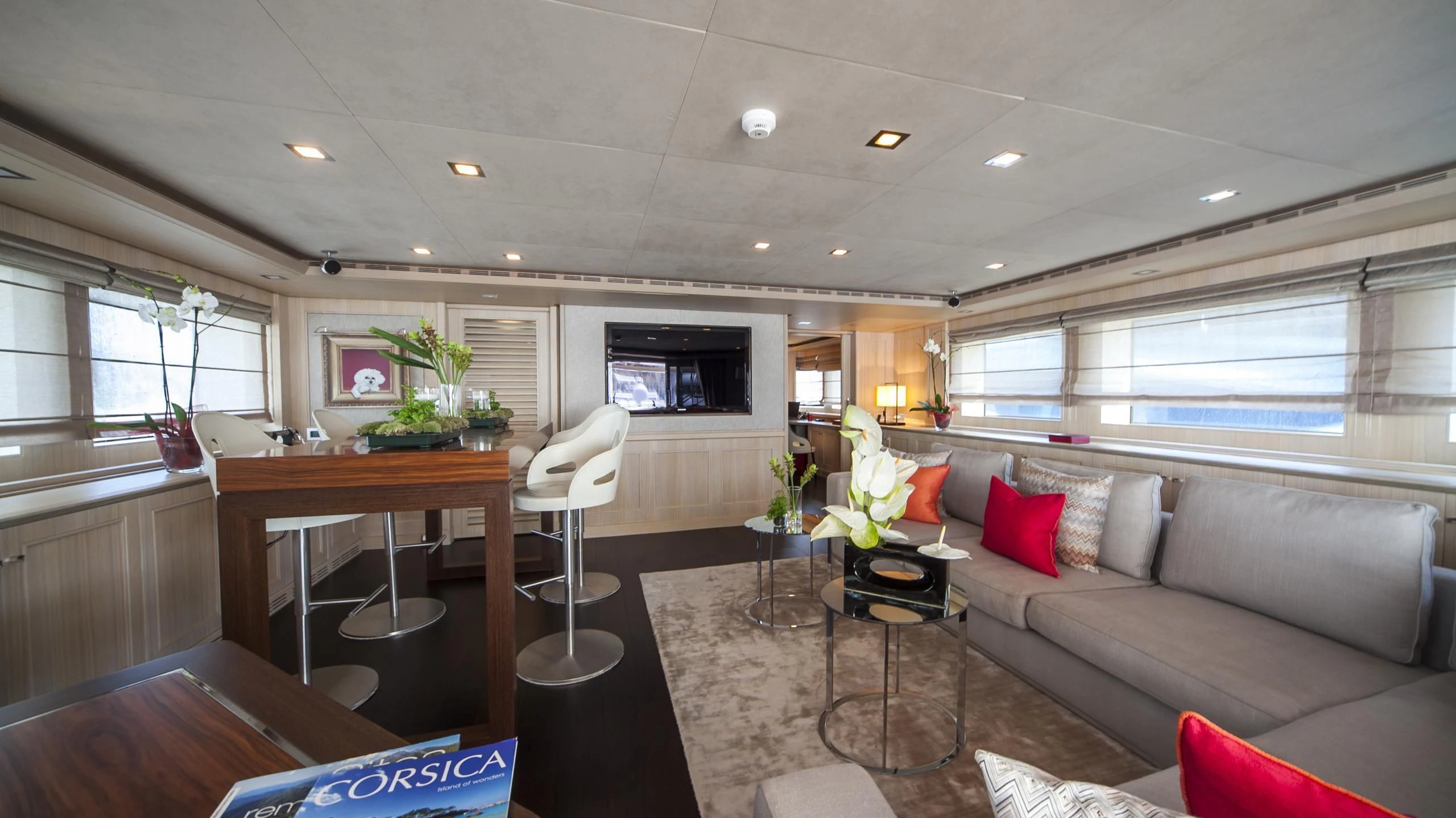 a living room with a couch and a coffee table aboard PHOTON Yacht for Sale