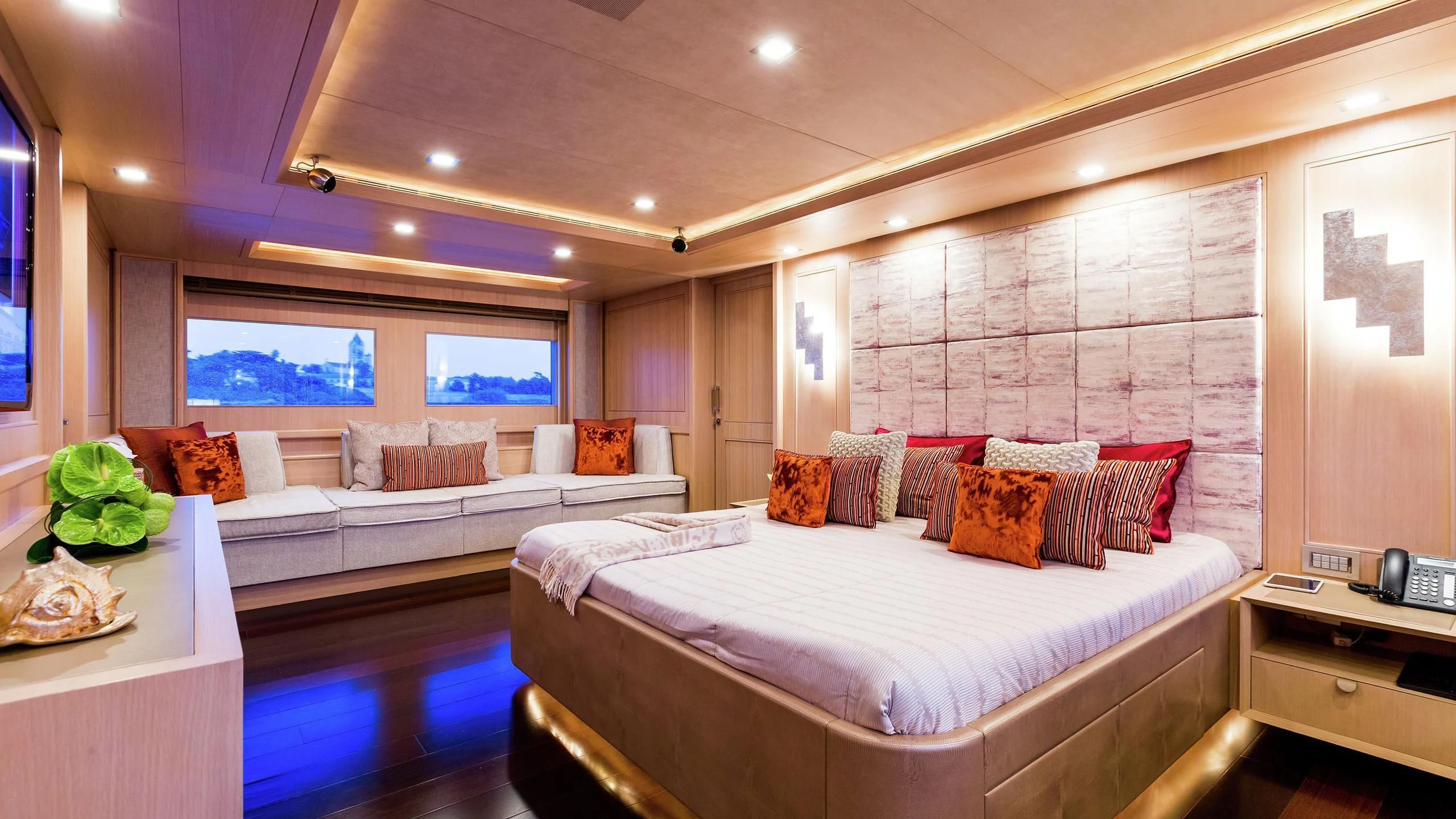 a room with a bed and a table aboard PHOTON Yacht for Sale