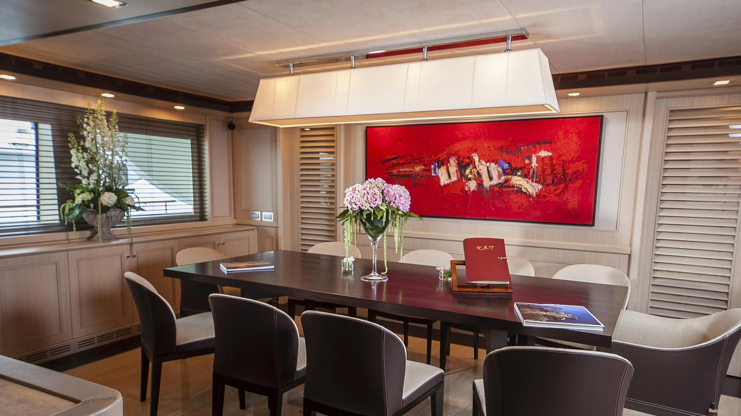 a large room with a table and chairs aboard PHOTON Yacht for Sale
