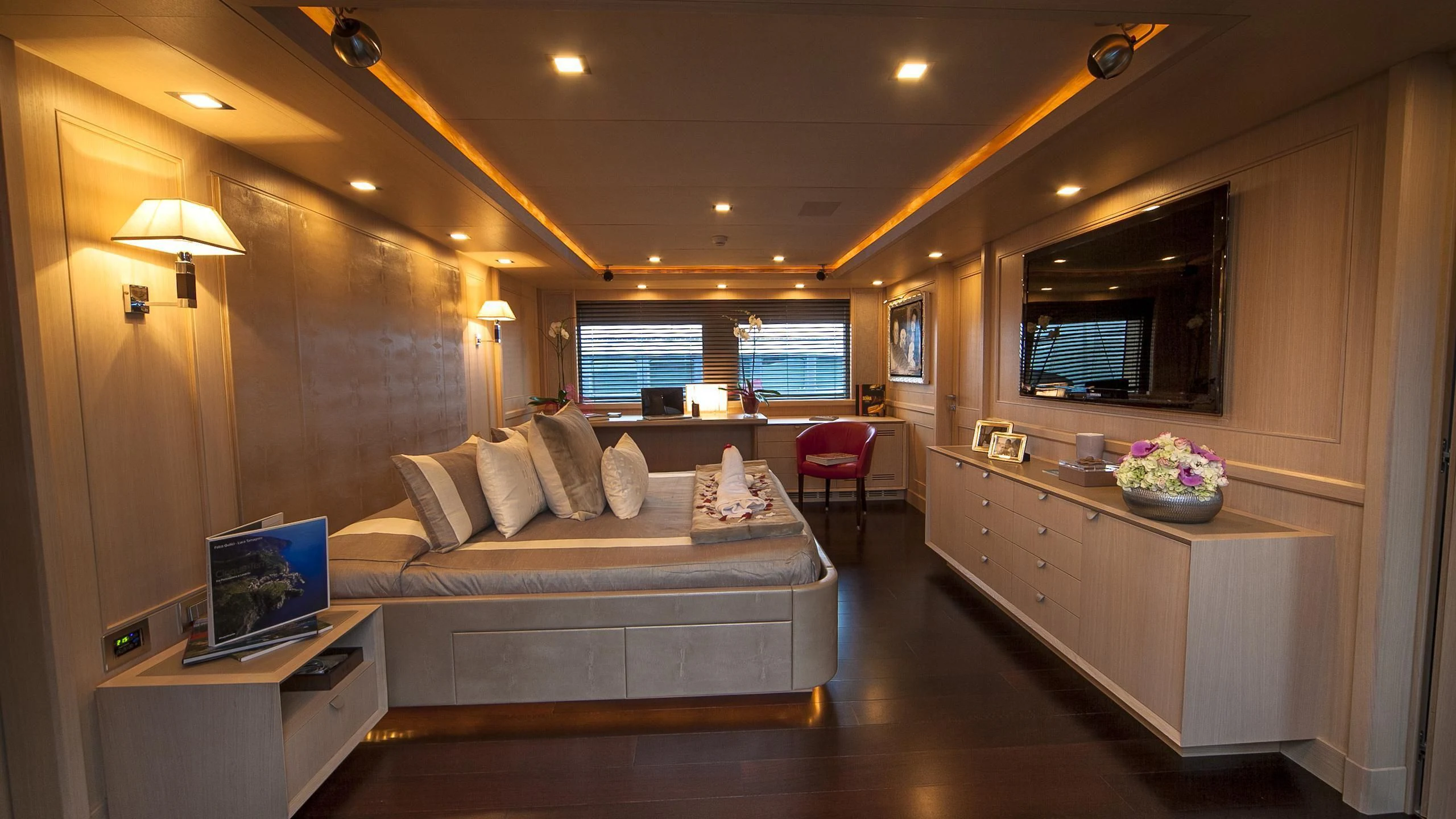 a large bedroom with a large bed aboard PHOTON Yacht for Sale
