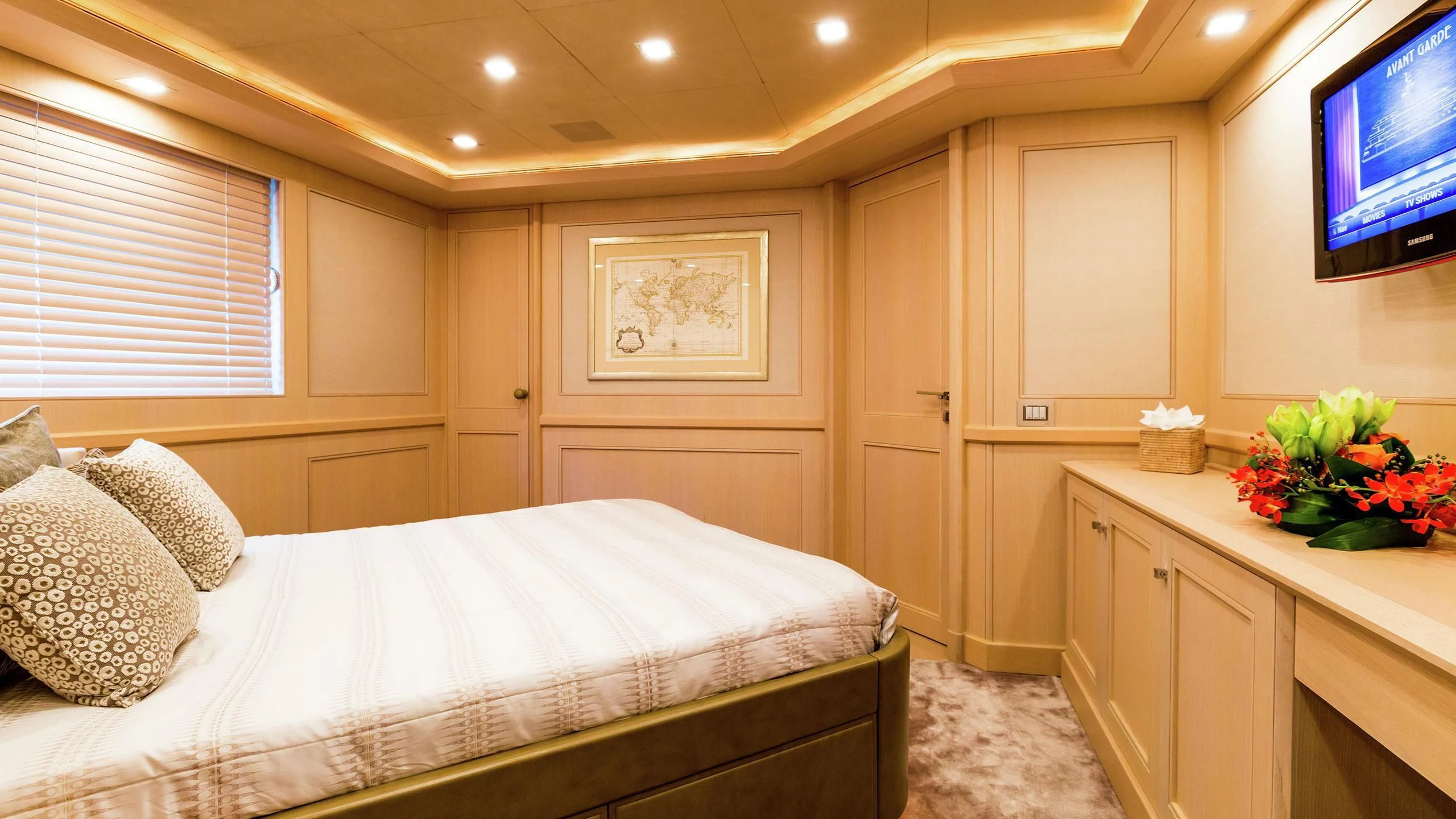 a bedroom with a bed and a tv aboard PHOTON Yacht for Sale