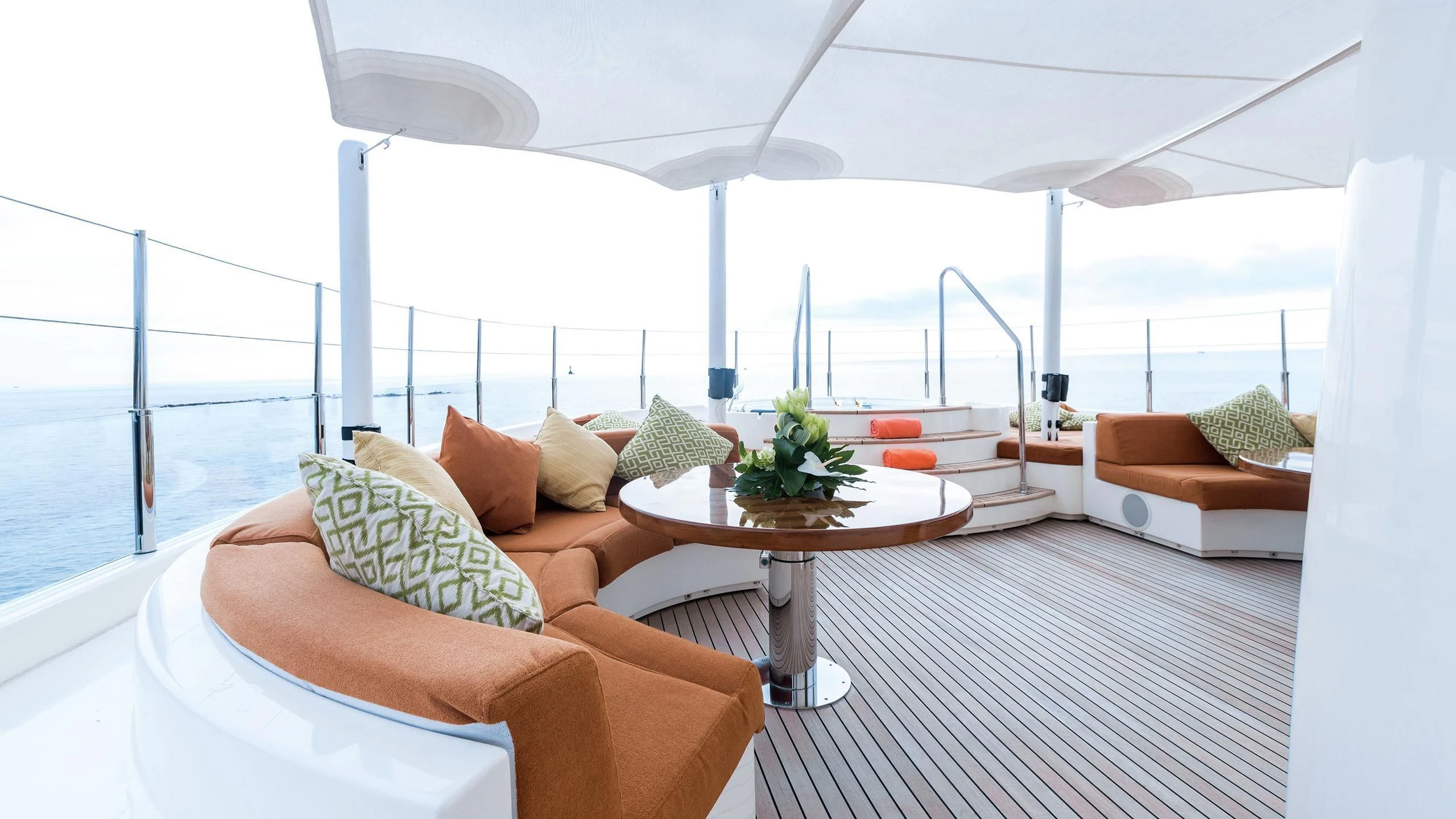 a room with a table and chairs aboard PHOTON Yacht for Sale