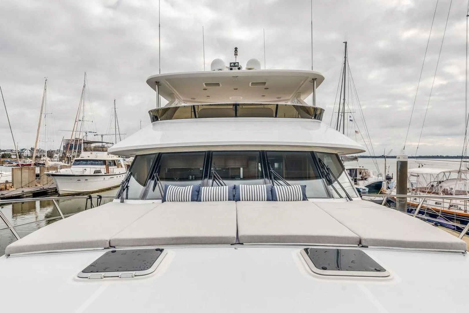 a white boat in a harbor aboard LADY GIGI Yacht for Sale