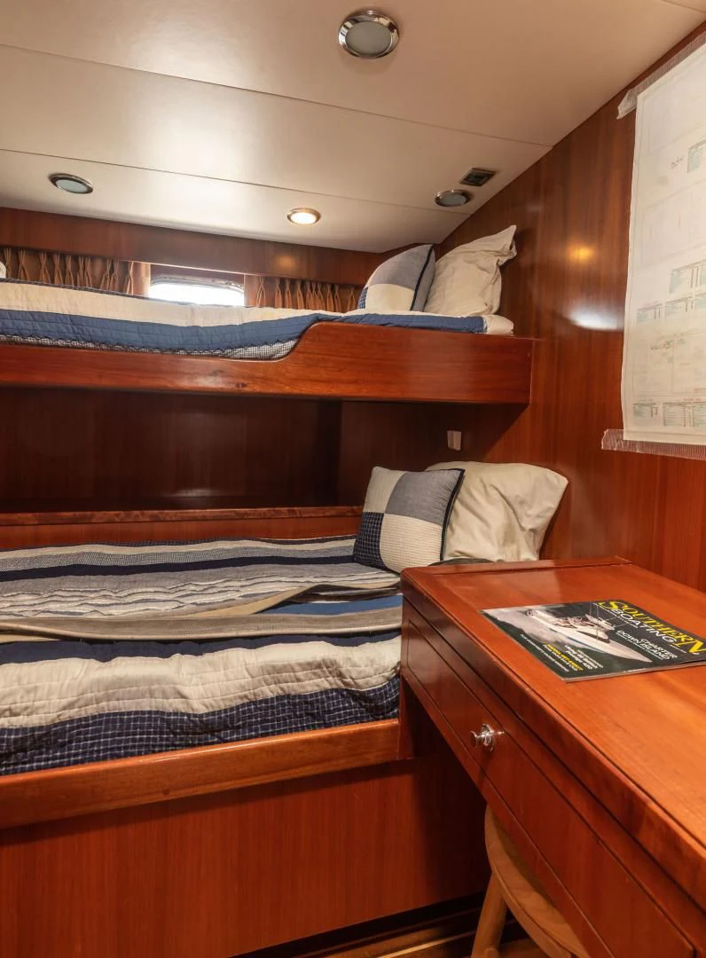 a bed with a wooden headboard aboard LADY GIGI Yacht for Sale