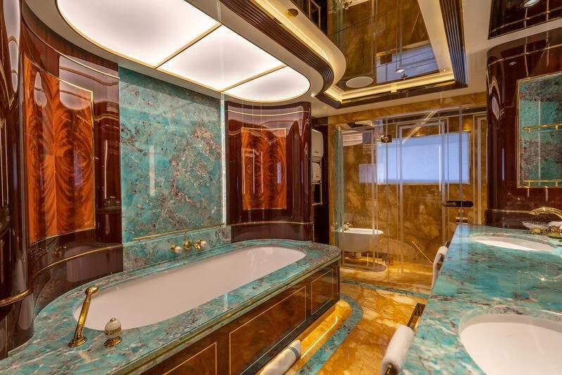 a bathroom with a tub and a sink aboard JEWELS Yacht for Sale