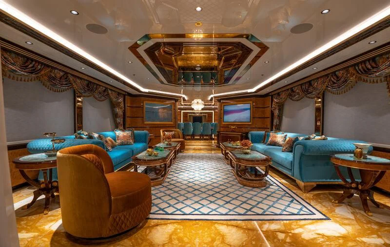 a living room with a large chandelier aboard JEWELS Yacht for Sale