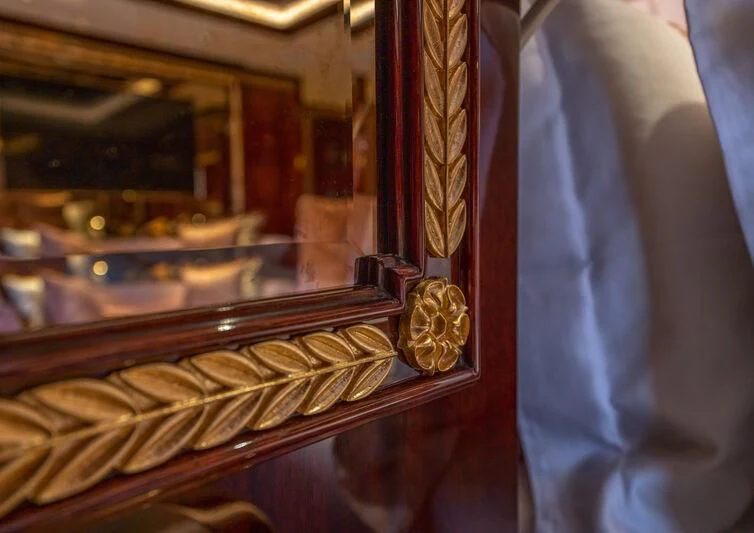 a suit and tie in a window aboard JEWELS Yacht for Sale
