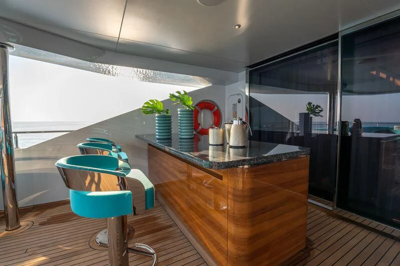 a kitchen with a table and chairs aboard JEWELS Yacht for Sale