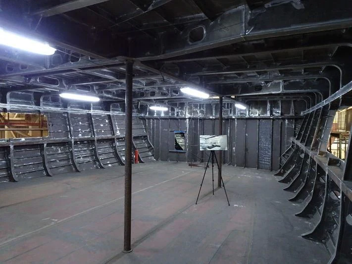 a large warehouse with large metal racks aboard JEWELS Yacht for Sale