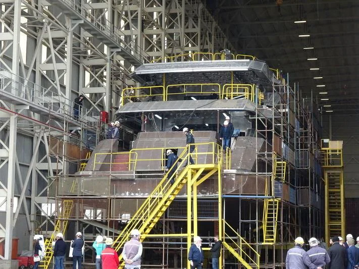 a large machine with people around it aboard JEWELS Yacht for Sale