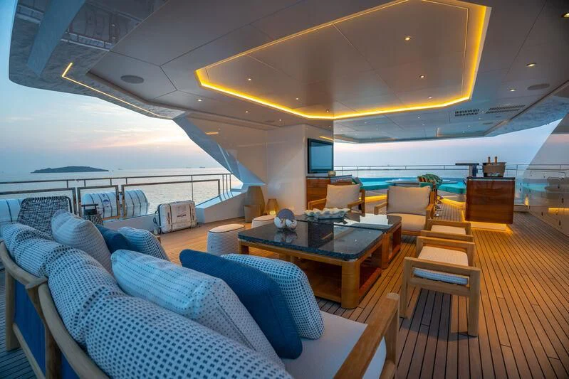 a boat with a table and chairs aboard JEWELS Yacht for Sale