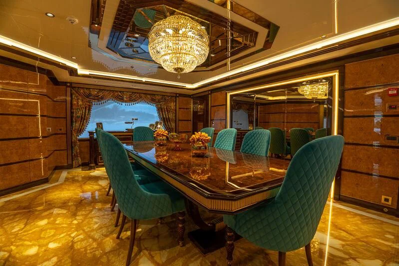 a room with a table and chairs aboard JEWELS Yacht for Sale