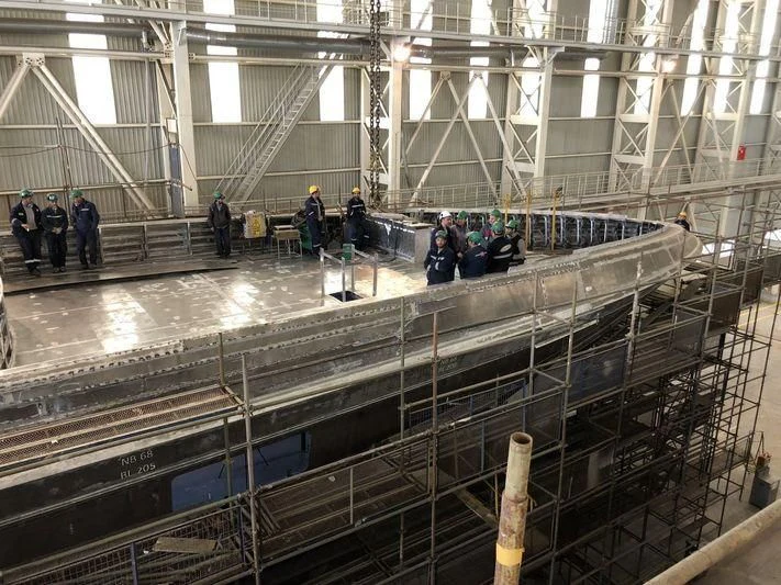 a group of people in a large room with a large staircase aboard JEWELS Yacht for Sale