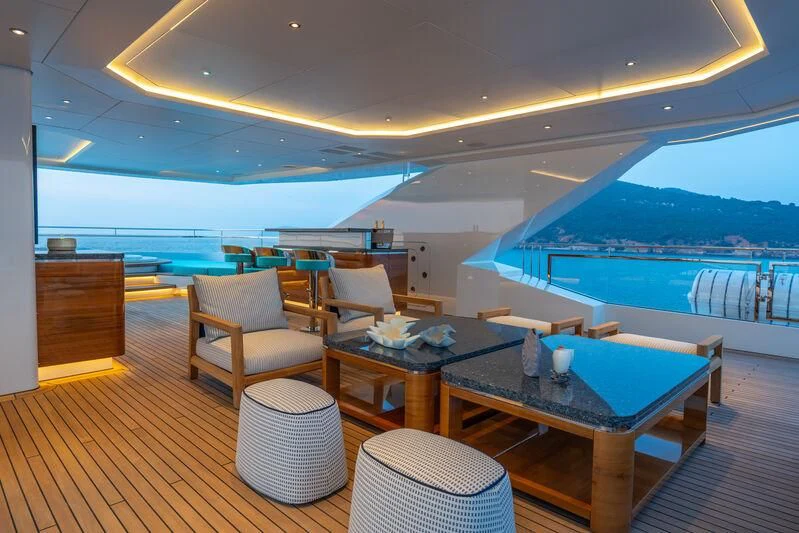 a room with a table chairs and a view of the ocean aboard JEWELS Yacht for Sale