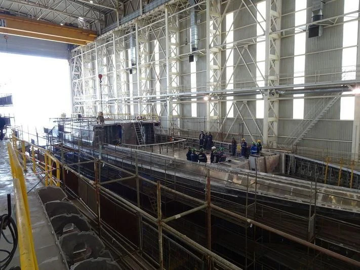 a large room with a large group of people in it aboard JEWELS Yacht for Sale