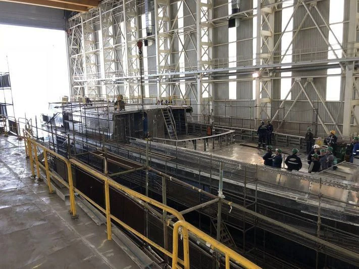 a large factory with several people aboard JEWELS Yacht for Sale
