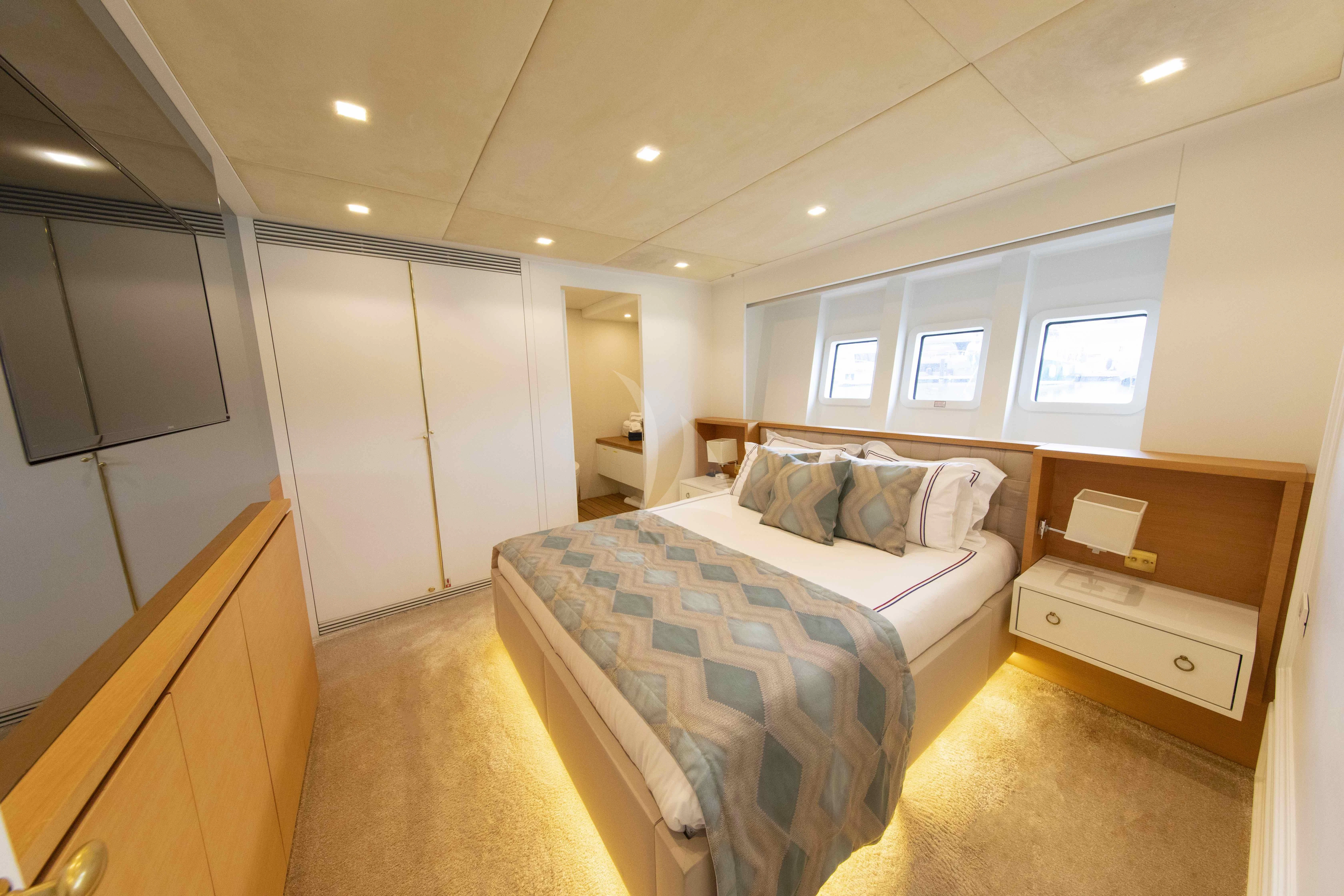 a bedroom with a bed and a desk aboard HARUN Yacht for Charter