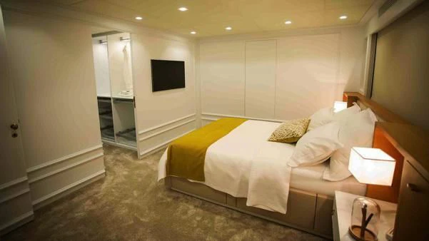 a bedroom with a bed and a television aboard HARUN Yacht for Charter