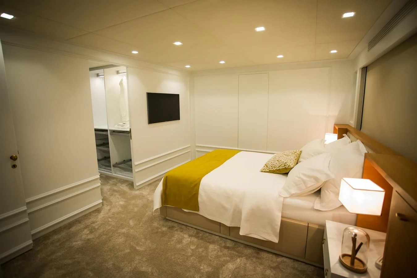 a bedroom with a bed and a television aboard HARUN Yacht for Charter