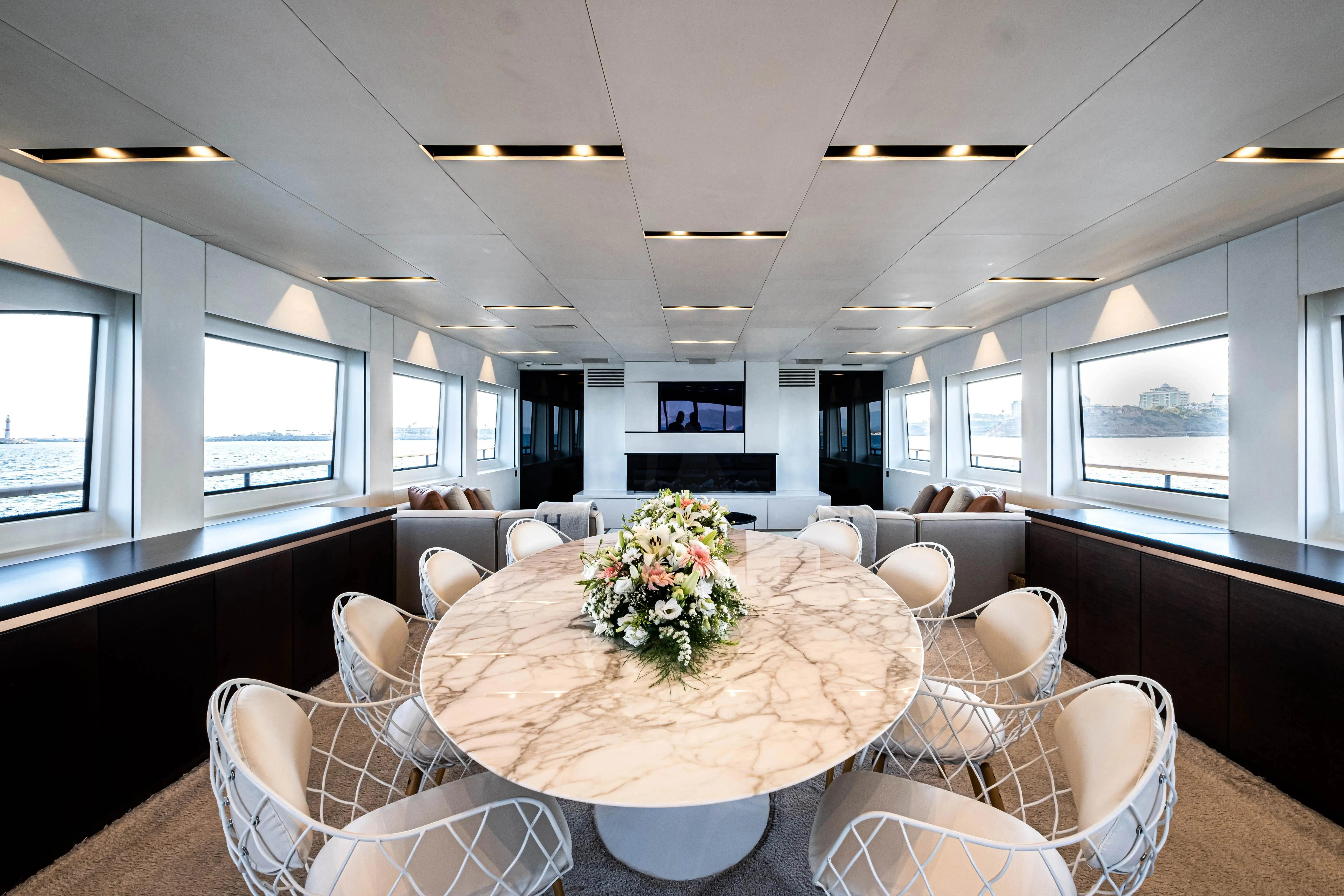 a large living room with a table and chairs aboard HARUN Yacht for Charter